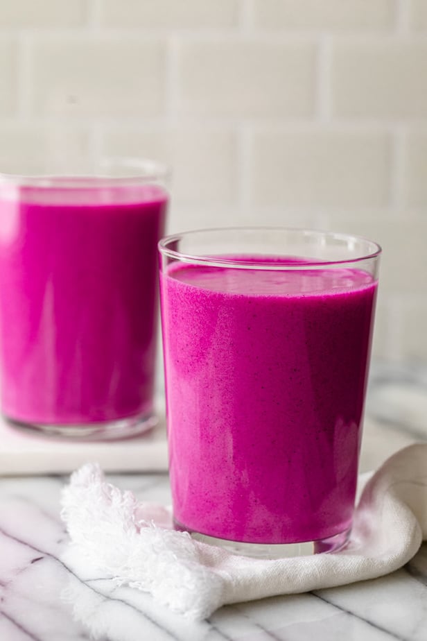 Two cups of pitaya smoothies in beautiful magenta colors