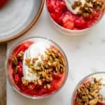 Strawberry parfait in small glass cups topped with granola