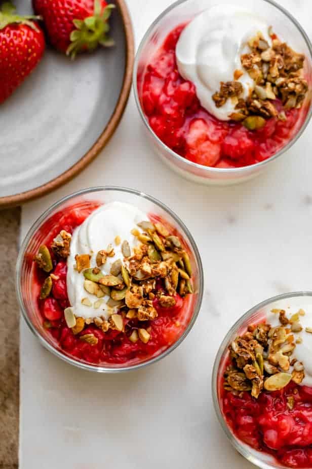 Strawberry parfait in small glass cups topped with granola