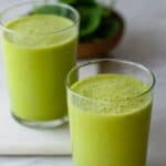 Superfood smoothies in two clear cups with bright green colors