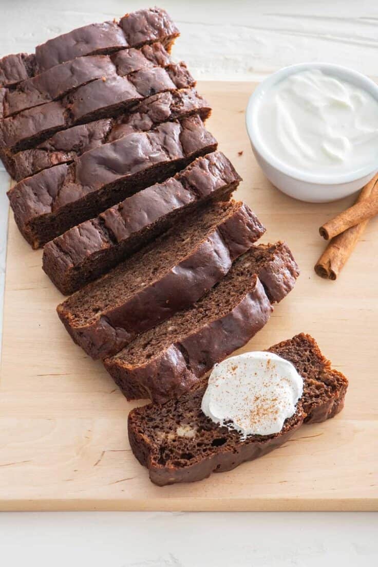 Chocolate cinnamon banana bread with dollop of greek yogurt and cinnamon sticks