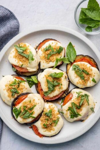 Grilled eggplant parmesan topped with grilled tomatoes, mozzarella cheese and parmesan breadcrumbs