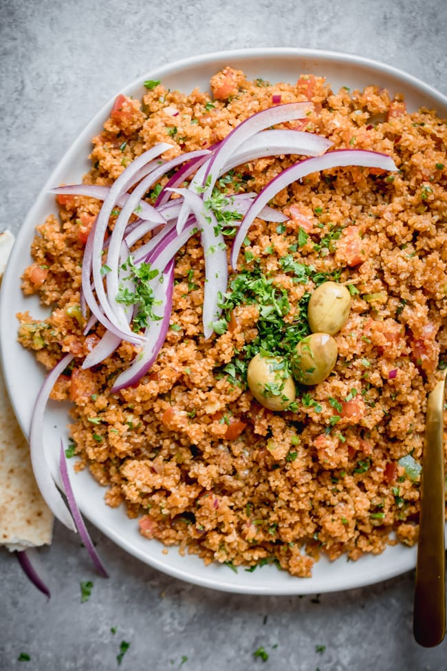 Bulgur pilaf plated with onions and green olives