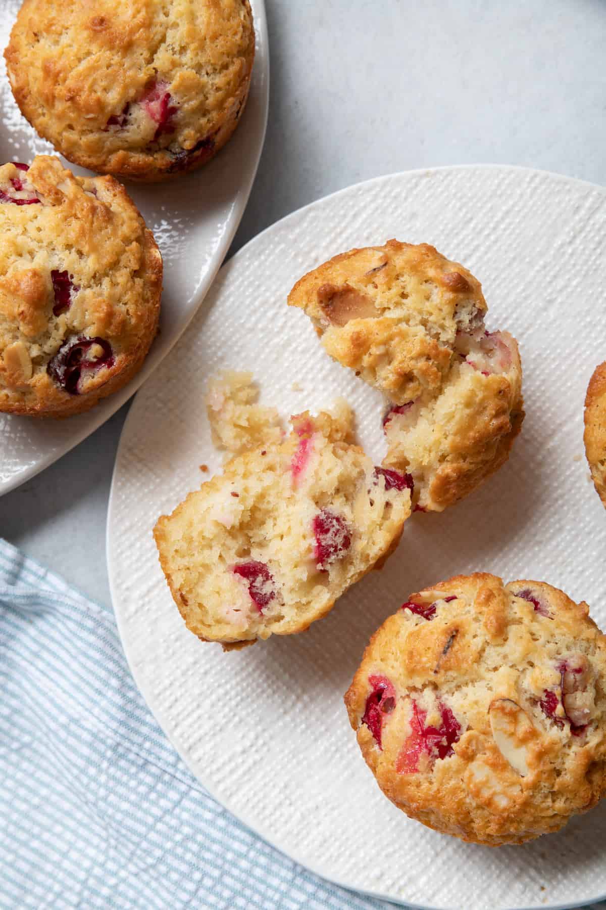 Plate two cranberry lemon muffins, one cut in half