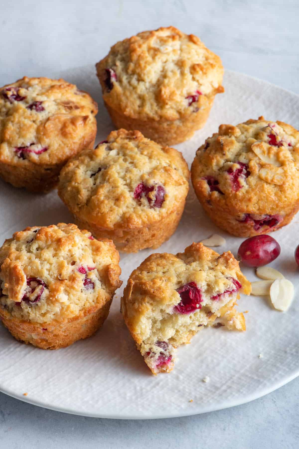 Plate of easy cranberry muffins with bite taken out of one