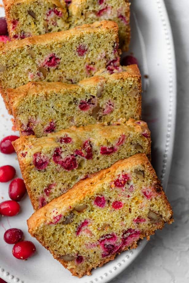 Cranberry orange bread on a white plate after sliced
