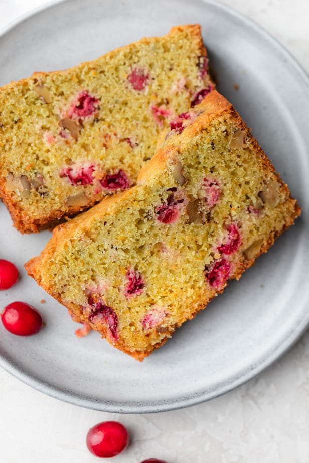 Two slices of cranberry orange bread on a plate