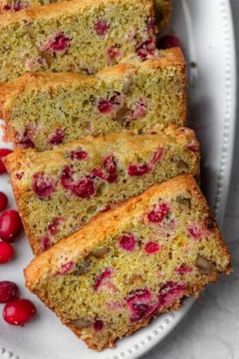 Cranberry orange bread on a white plate after sliced