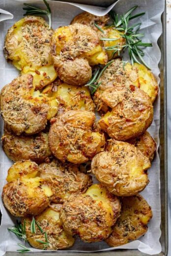 These Rosemary Garlic Smashed Potatoes are a best of both worlds potato recipe - mashed and roasted! They are soft on the inside, crispy on the outside and bursting with rosemary garlicky flavor. It's a creative healthy side-dish the whole family will love!