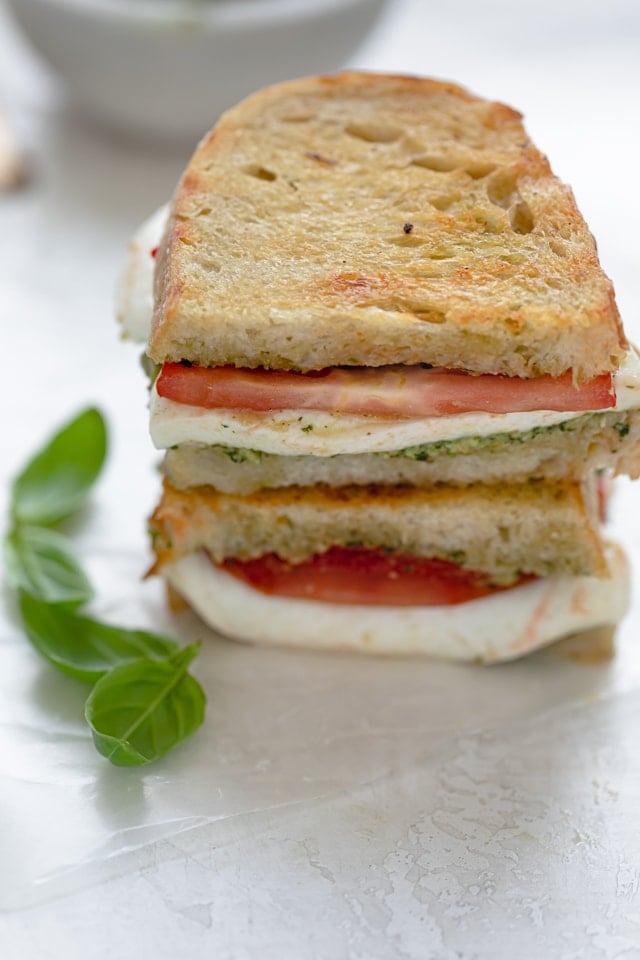 Mozzarella Grilled Sandwich stacked with basil on the side