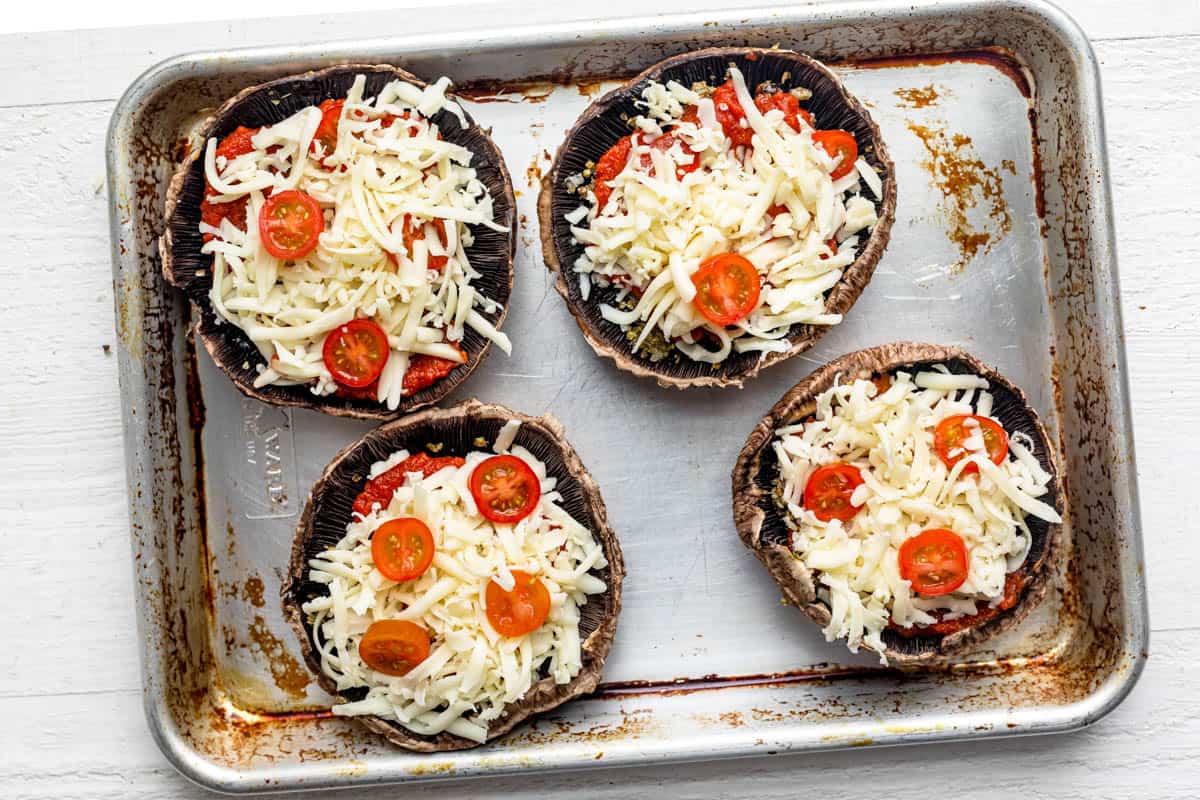 Portobello mushrooms on a baking sheet before going in the oven