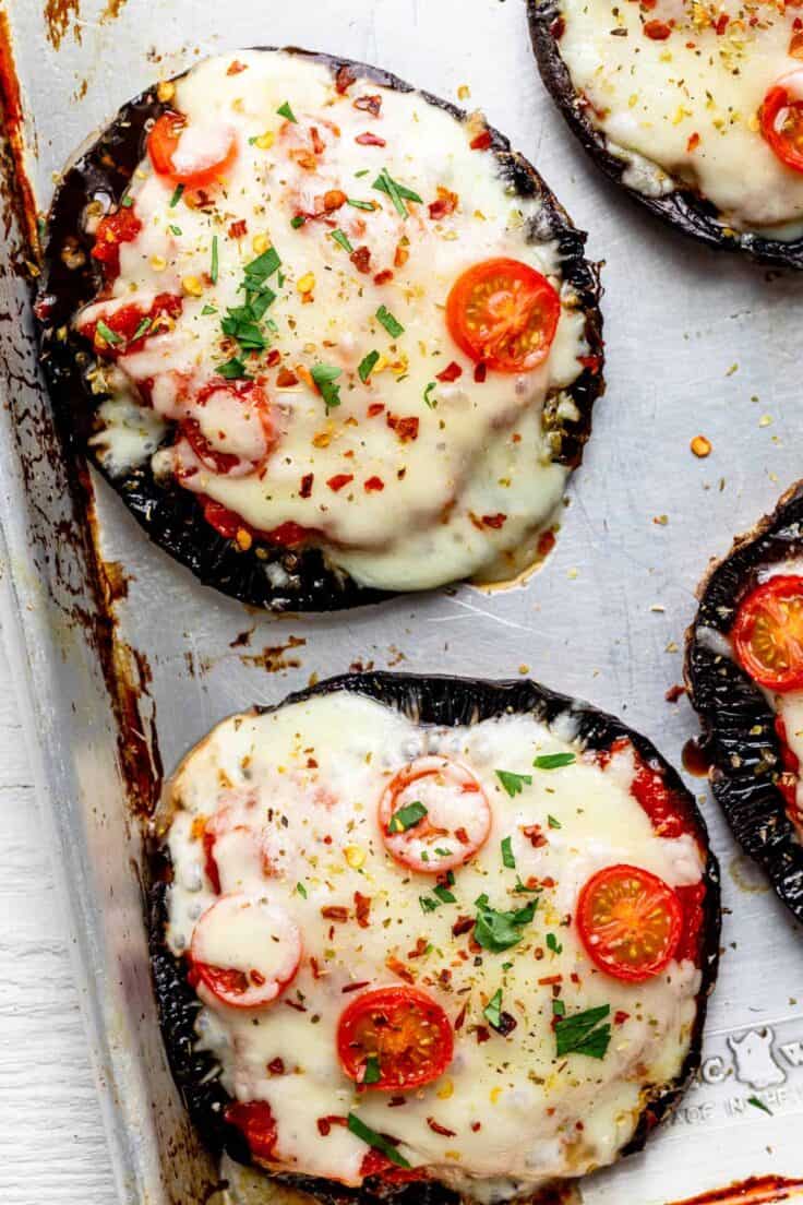 Close up shot of the portobello mushroom pizzas with the toppings after cooking with cheese melting