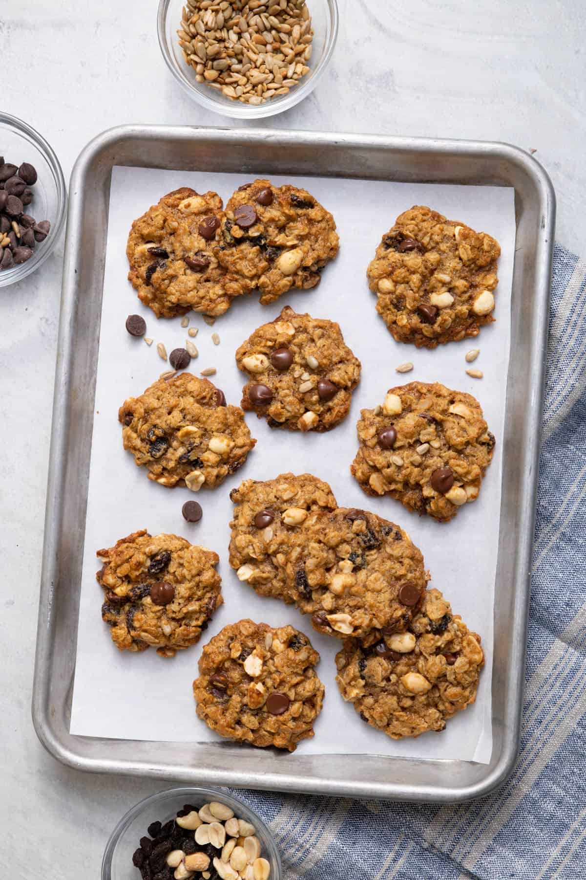 Sheet pan of the trail mix cookies with parchment paper