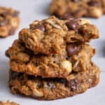Stack of 3 trail mix cookies on parchment paper