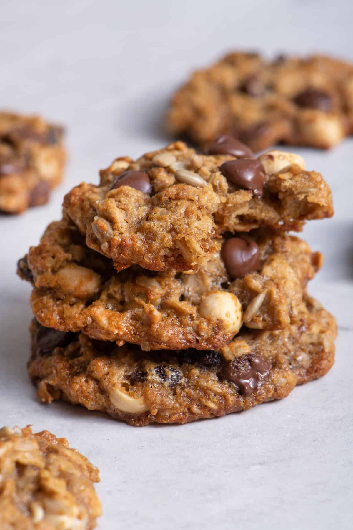 Stack of 3 trail mix cookies on parchment paper