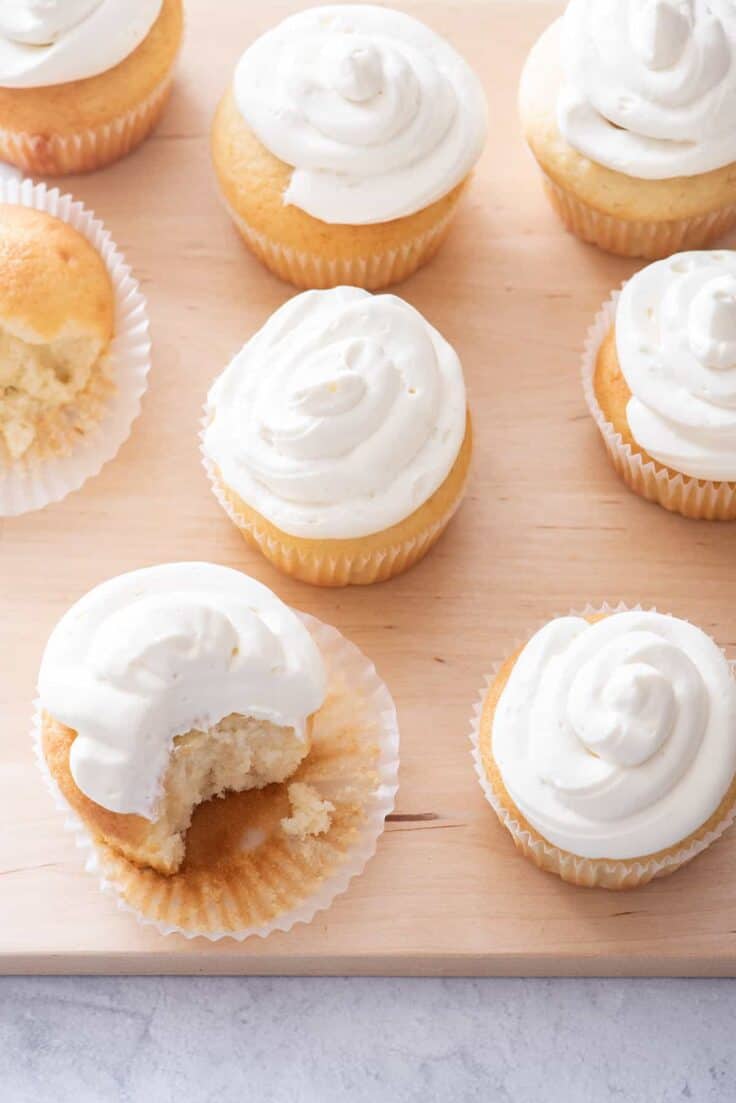 Vanilla cupcakes with bite taken out of one to show consistency