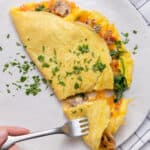 Veggie omelette stuffed with red onions, peppers, mushrooms, spinach and cheese