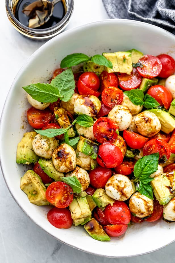 Avocado caprese salad drizzled with balsamic glaze