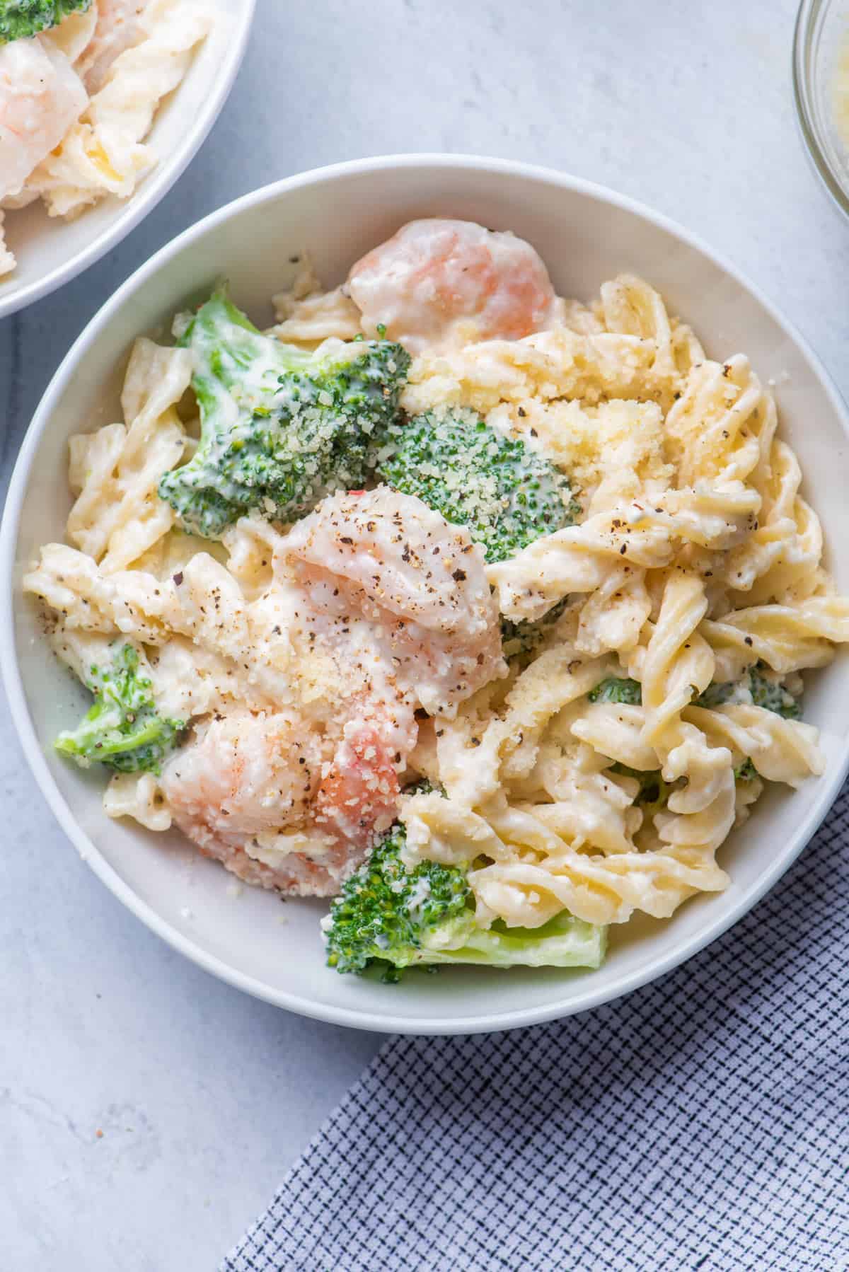 Broccoli shrimp pasta alfredo served in a large bowl