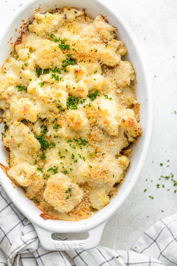 Final cauliflower au gratin recipe out of the oven topped with parsley