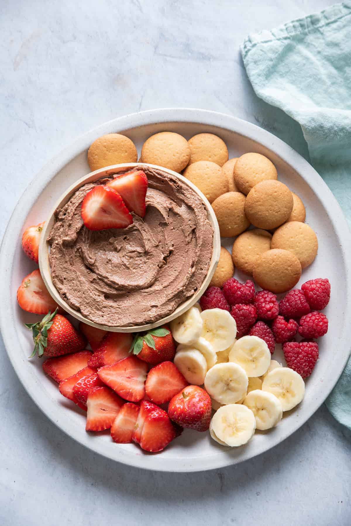 This Chocolate Peanut Butter Dip on a platter with fruit and crackers
