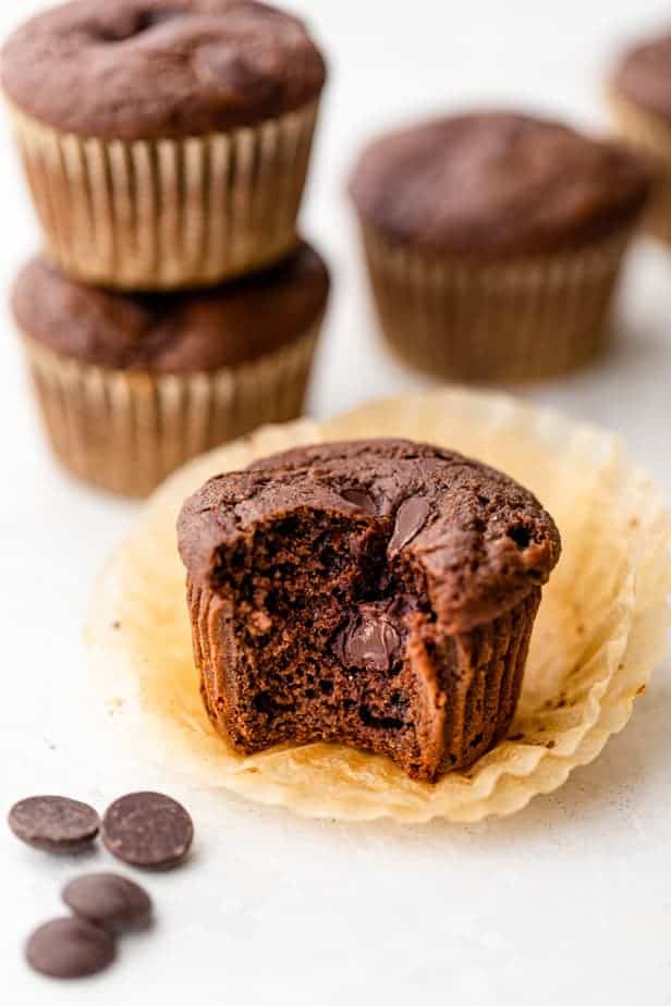 Bite taken out of double chocolate chip muffin