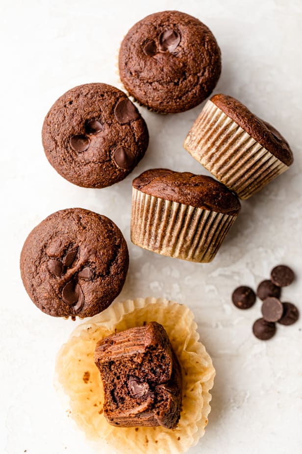 Double chocolate chip muffins on white surface