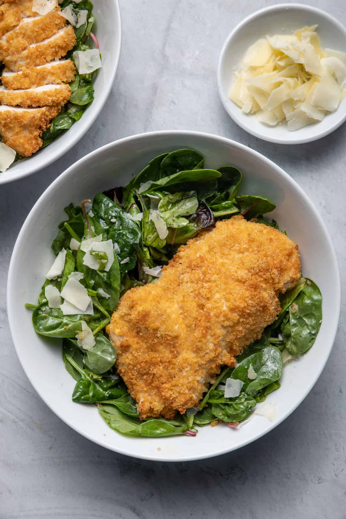 Bowl of tossed salad with Fried Chicken Parmesan on top