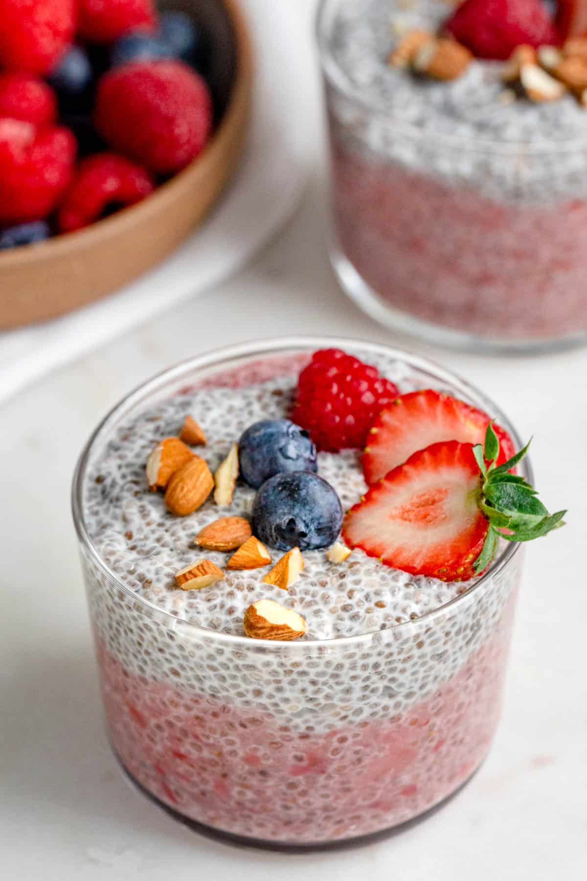 Two small glass jars of layered chia pudding