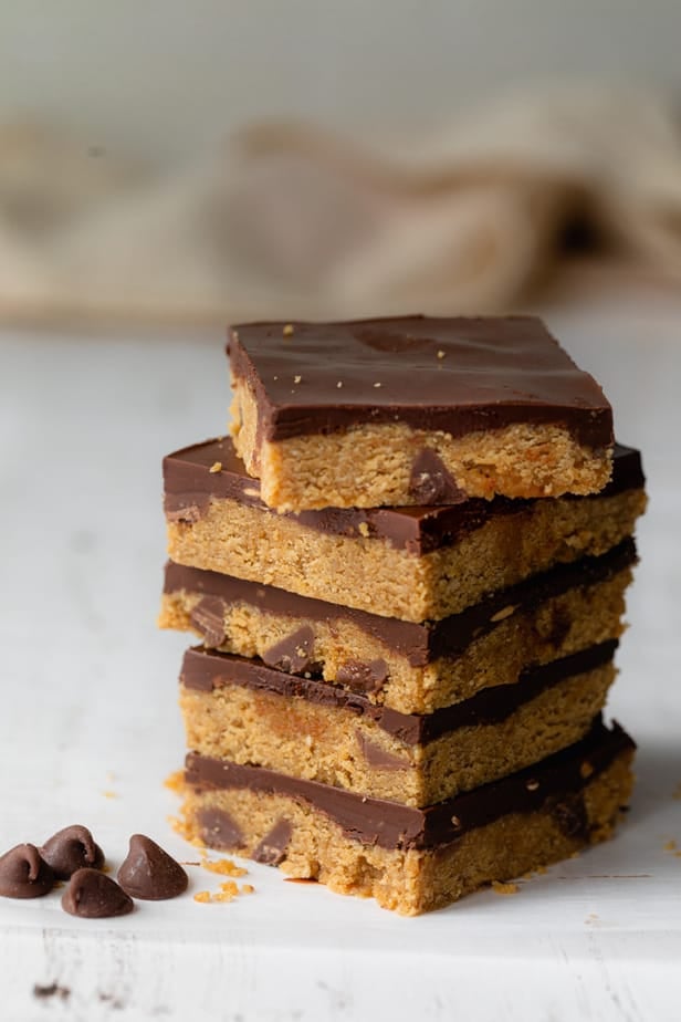 Stack of cookie doughbars on white surface