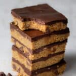 No bake cookie dough bars stacked on top of each other and top one bite taken out of it