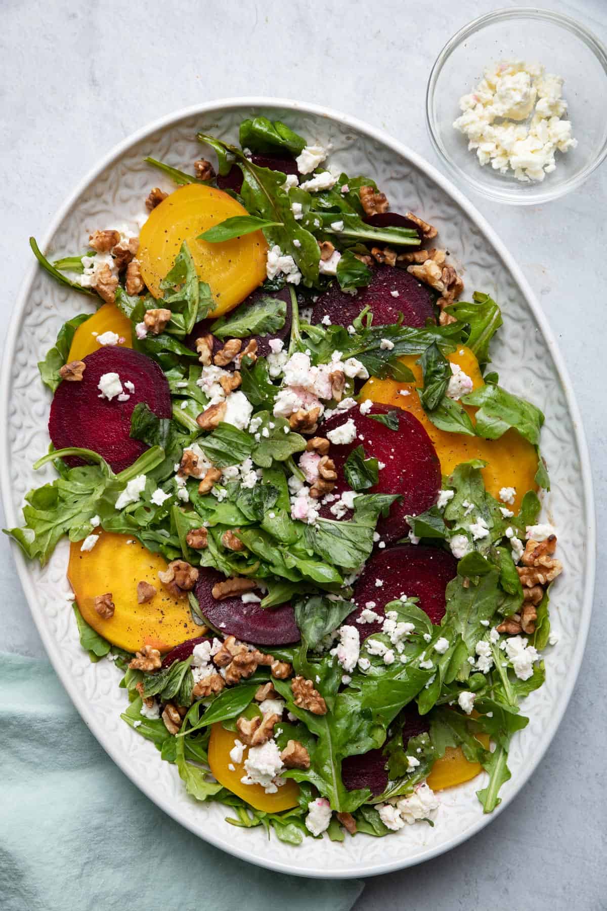 Roasted Beets Arugula Tomato Feta Salad - a fresh and light side salad in a large platter with feta cheese on the side