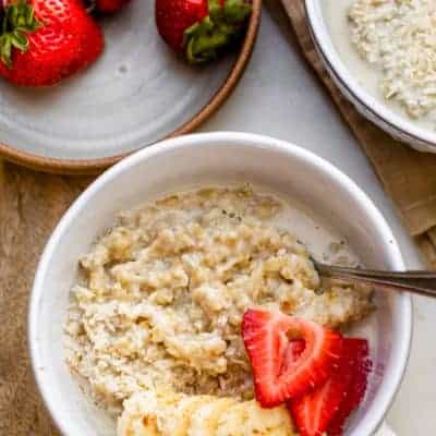 Close up shot of steel cut oatmeal topped with banana, strawberries and coconut