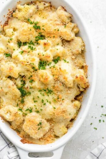 Final cauliflower au gratin recipe out of the oven topped with parsley