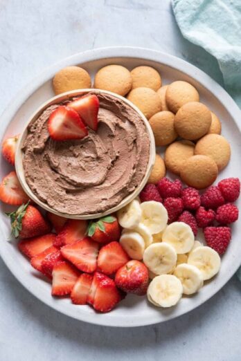 Chocolate Peanut Butter Dip on a plate with fruit and wafers for dippings