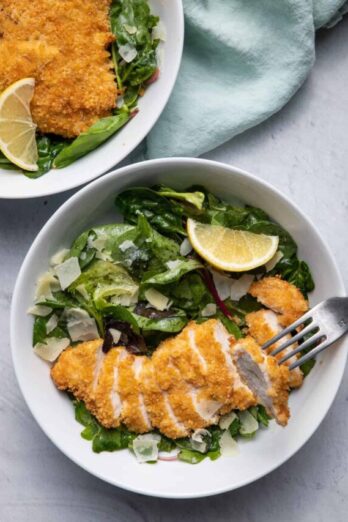 Fried Chicken Parmesan Salad in two bowls with fork grabbing a bite