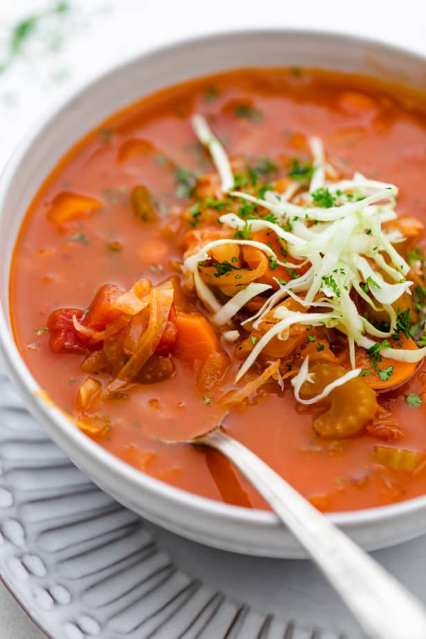 Tomato soup with cabbage in a white bowl