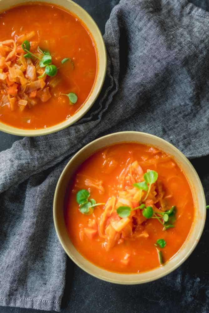 overhead shot of tomato cabbage soup in bowls