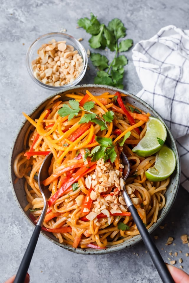 Large bowl of prepared Asian Noodle Salad being tossed in a bowl