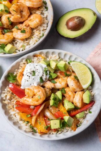 Two bowls of shrimp fajitas served over cilantro lime rice