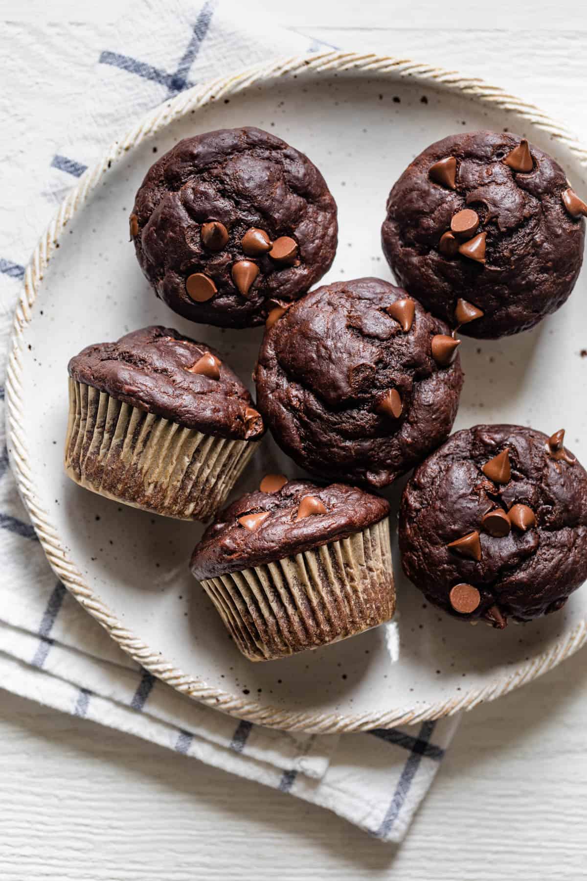 Chocolate banana muffins on a white plate - 6 total