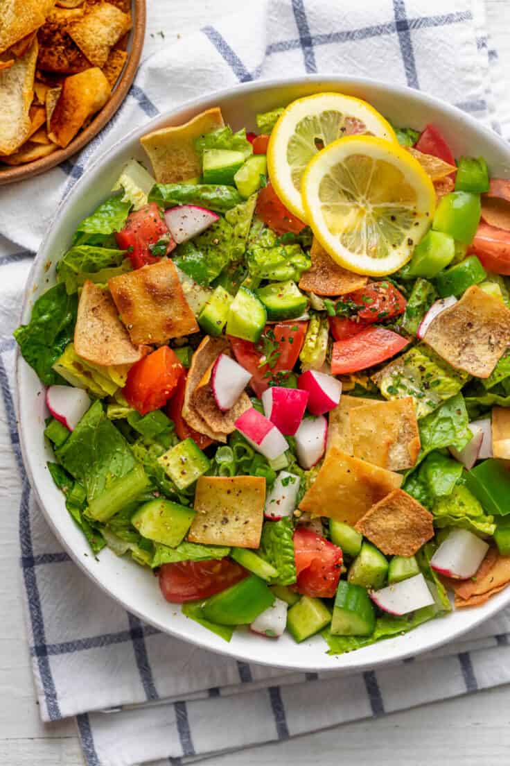 Large bowl of Lebanese Fattoush Salad with small bowl of fried pita bread on the side