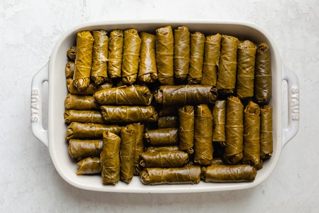 Tray of rolled grape leaves before cooking