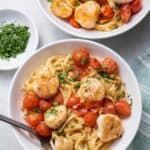 Two large bowls of pan seared scallops with cherry tomatoes and linguine pasta