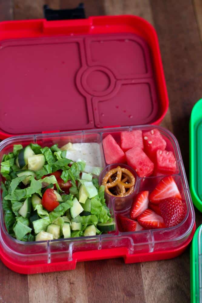 lunchbox with chopped salad pretzels and fruit