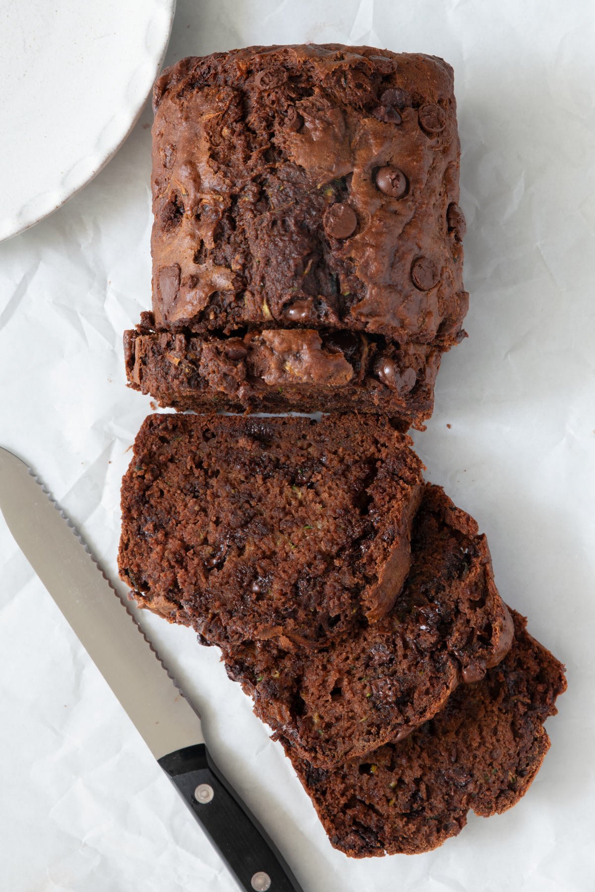 This Chocolate Chip Zucchini Bread is a moist and cake-like bread that sneaks in a cup and half of vegetables into dessert - no one will even know!