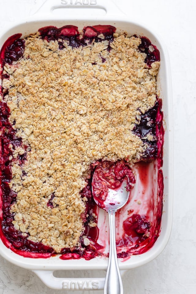 Mixed berry crisp in a white baking dish