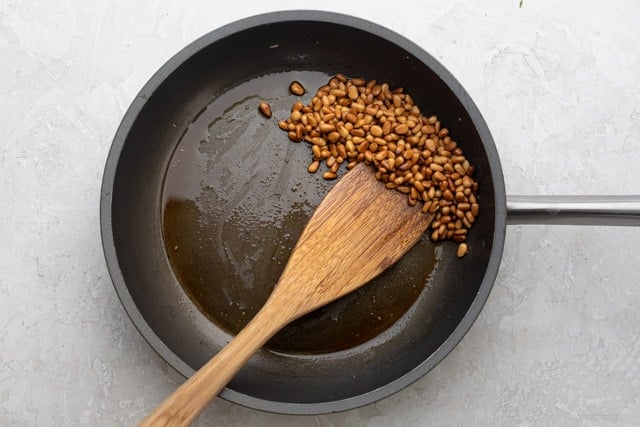 Frying pan with fried pine nuts