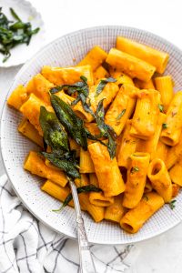 Final Pumpkin Pasta recipe plated in a large bowl and served with crispy sage