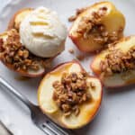 Cinnamon Baked Apples with Oats & Pecans mixture on top and scoop of vanilla ice cream